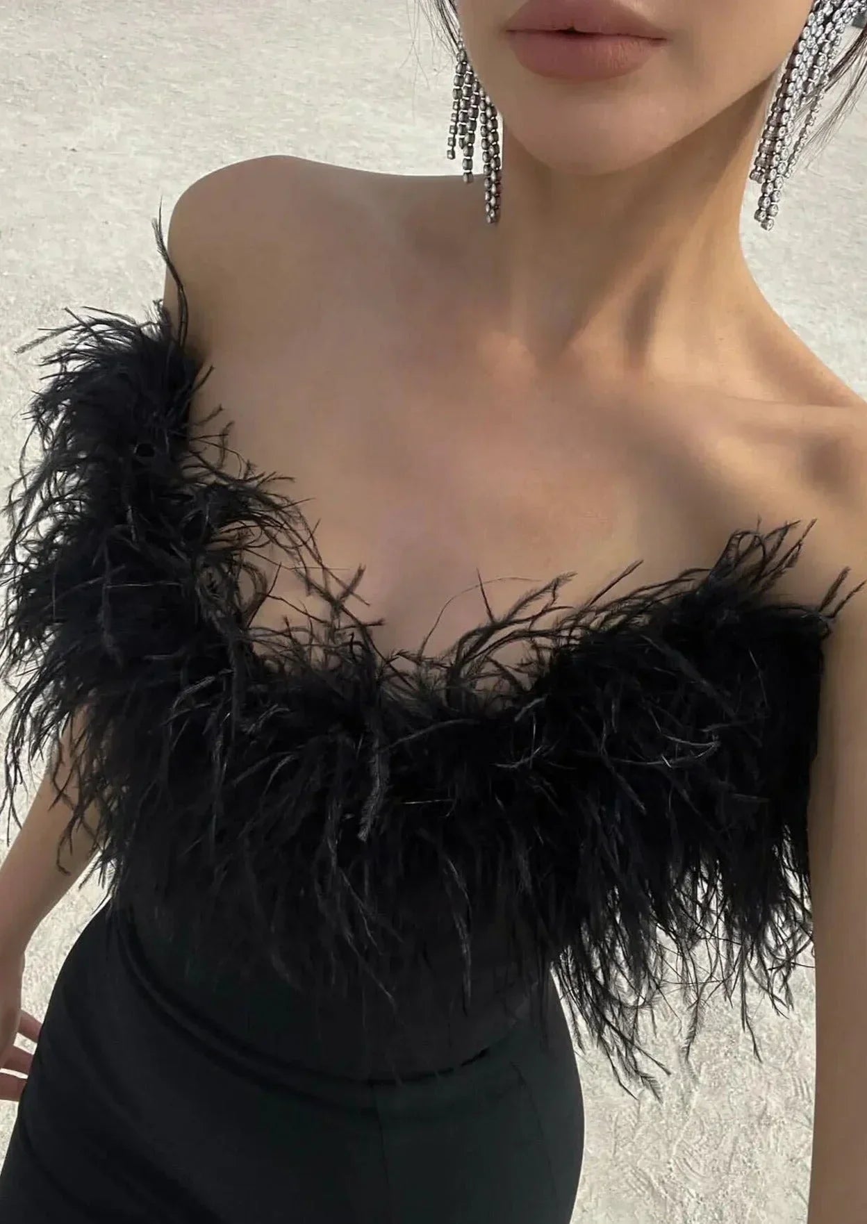 Vestido largo negro sin tirantes con detalle de plumas